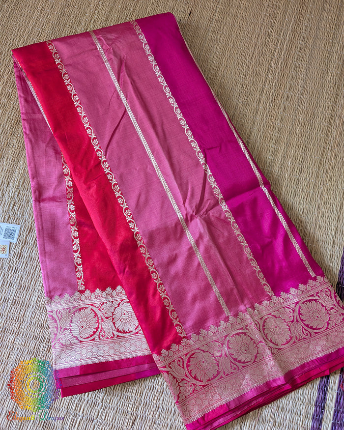 Folded pink shaded red Banarasi handloom Katan silk saree showing woven texture