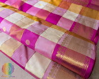 Close-up of the fabric showcasing the elegant checked weave and 2-Gram Gold Zari details of the Pink Gold Pure Kanjivaram Silk Saree