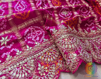 Border of rani pink bandhani gaji silk dupatta highlighting gota patti work
