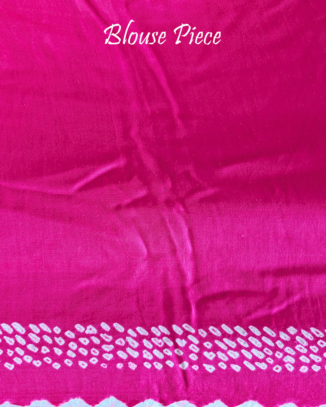 Matching blouse piece in rani pink bareek bandhej gaji silk fabric showing pattern detail