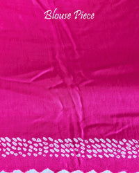 Matching blouse piece in rani pink bareek bandhej gaji silk fabric showing pattern detail