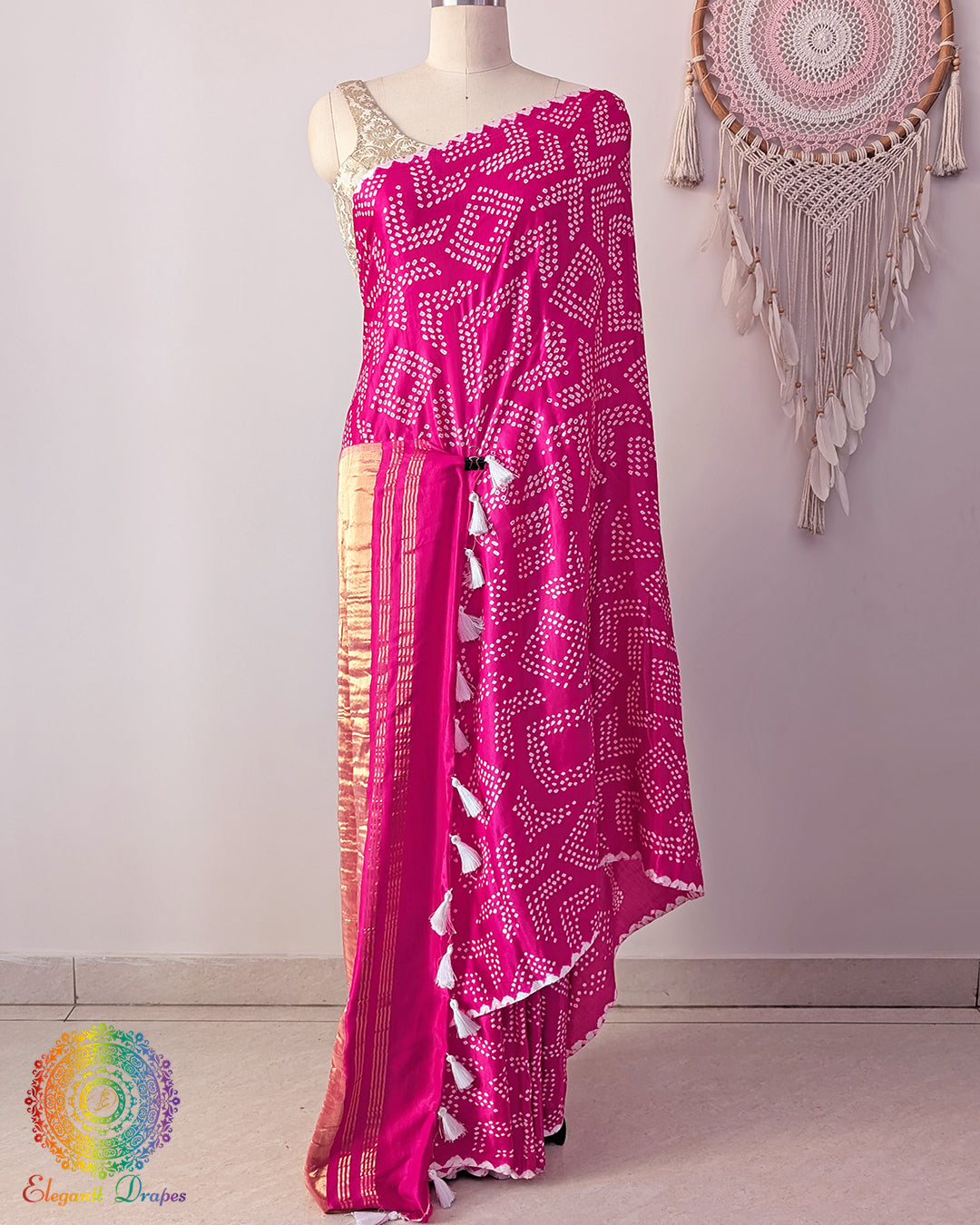 Rani pink pure gaji silk saree on mannequin showcasing fine bareek bandhej pattern