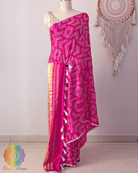 Rani pink pure gaji silk saree on mannequin showcasing fine bareek bandhej pattern