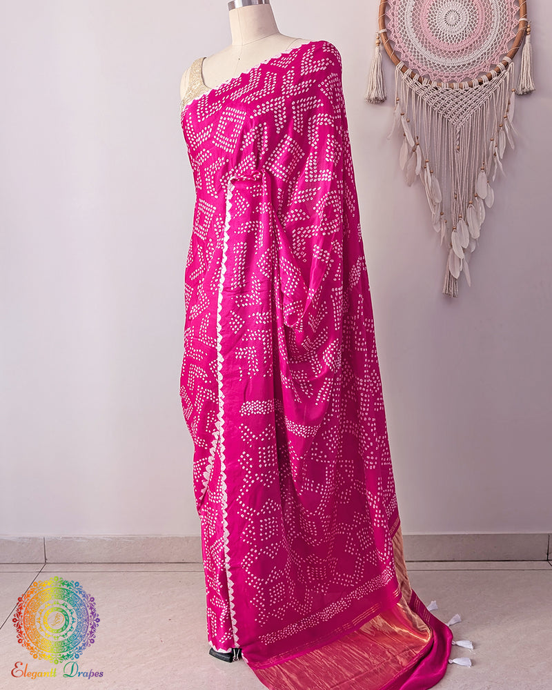Side angle view of rani pink bandhani silk saree on mannequin highlighting palla fall