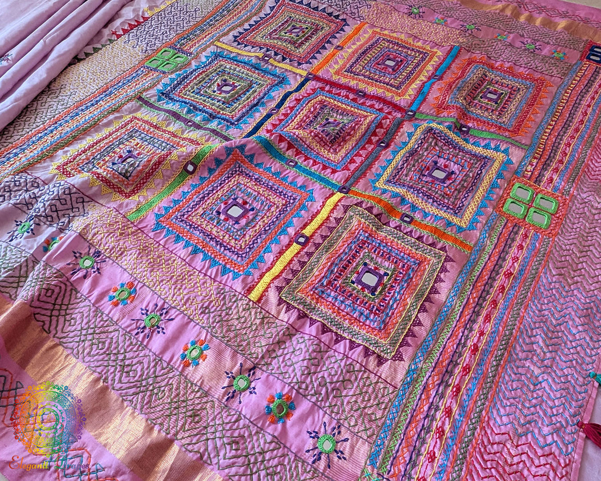 Close-up of the Pastel Pink Kanjivaram Silk Saree showing Sindhur Lambani hand embroidery, with intricate threadwork and decorative details against the pink silk fabric.