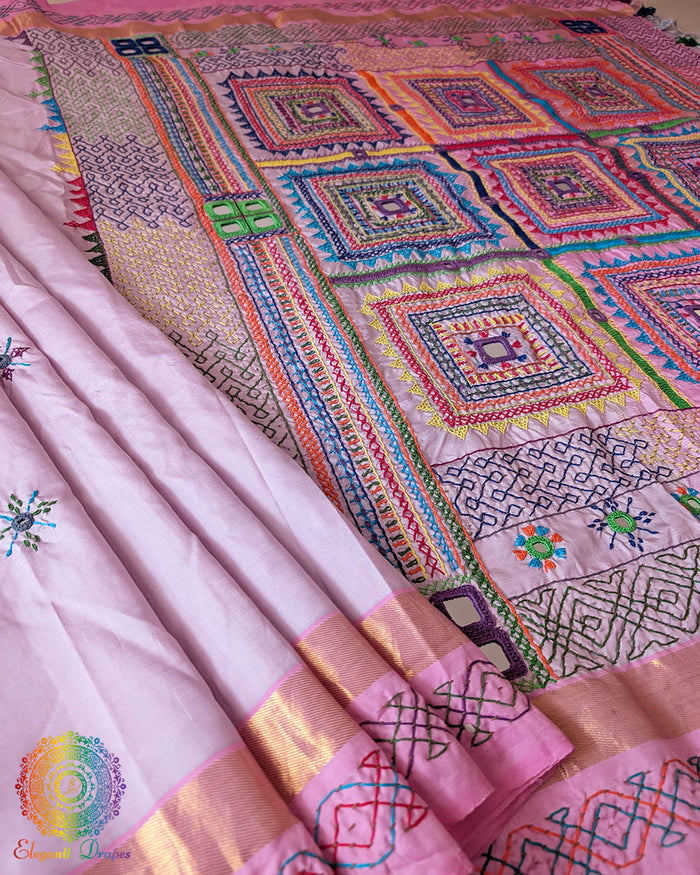 Pastel Pink Kanjivaram Silk Saree with Sindhur Lambani Handwork shown in a full open view, highlighting the soft pink silk body and colourful traditional embroidery.