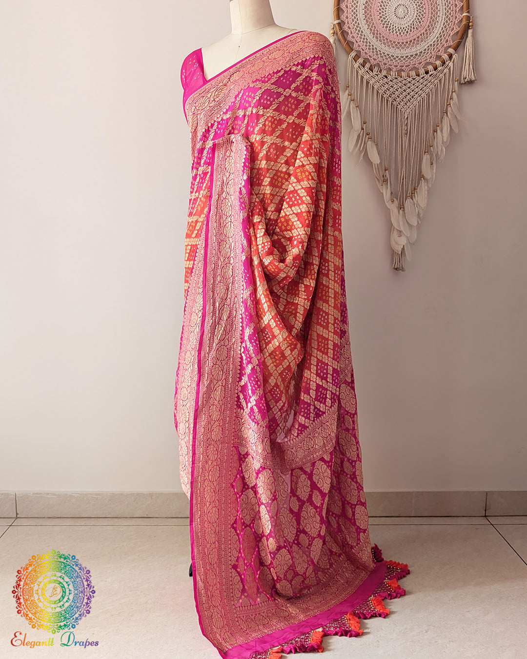 Side view of pink orange shaded Khaddi georgette Banarasi Bandhani saree showcasing elegant drape