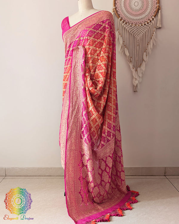 Side view of pink orange shaded Khaddi georgette Banarasi Bandhani saree showcasing elegant drape