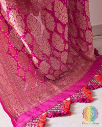 Close up of the Banarasi woven palla with handcrafted heavy tassels on the pink orange shaded Khaddi georgette saree