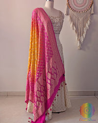 Side view of pink orange shaded Banarasi georgette Gharchola Bandhani dupatta showcasing elegant ombré shading, Gharchola checks, and Bandhani motifs