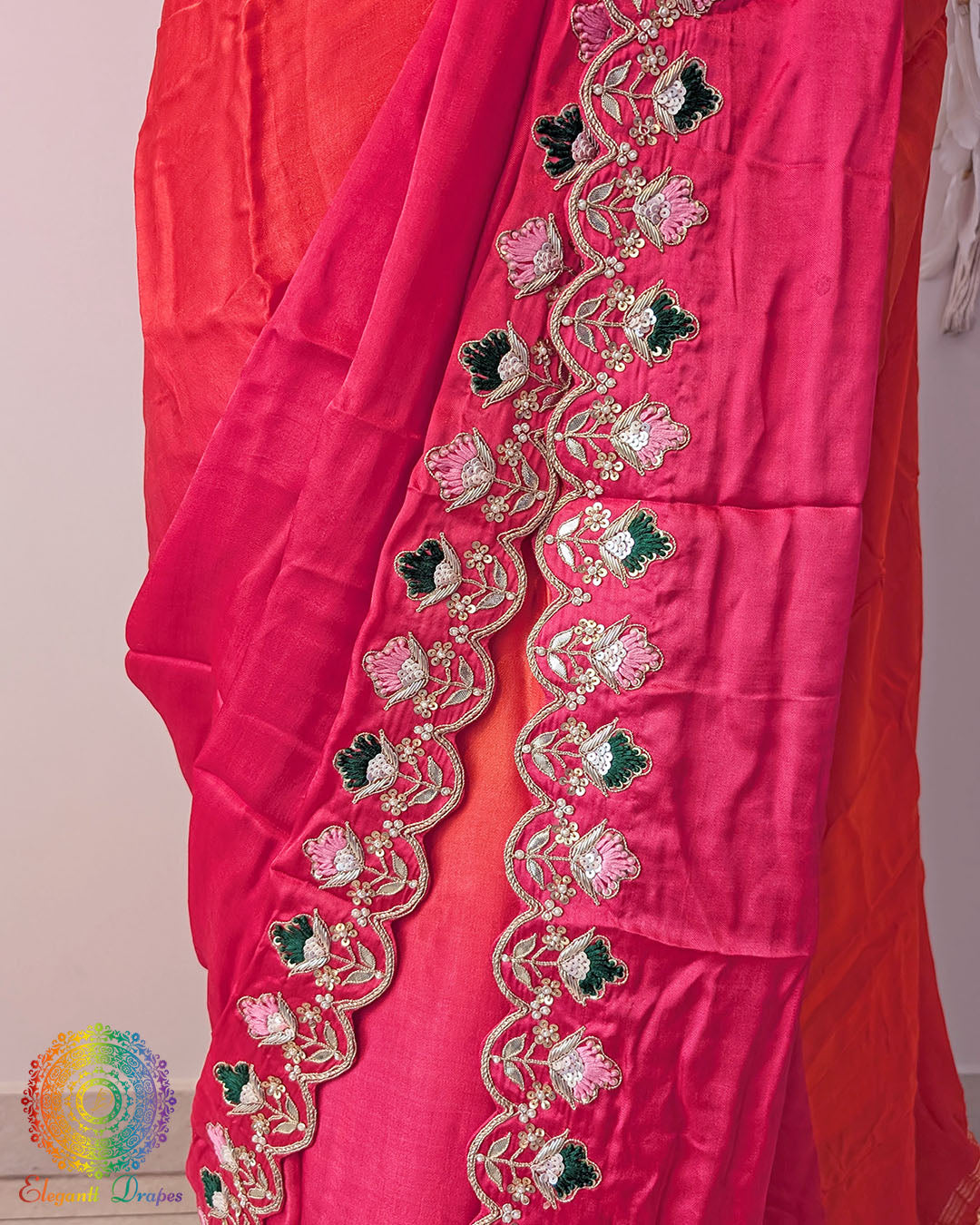 Close up of pink orange ombre shaded gaji silk saree highlighting gota patti and resham