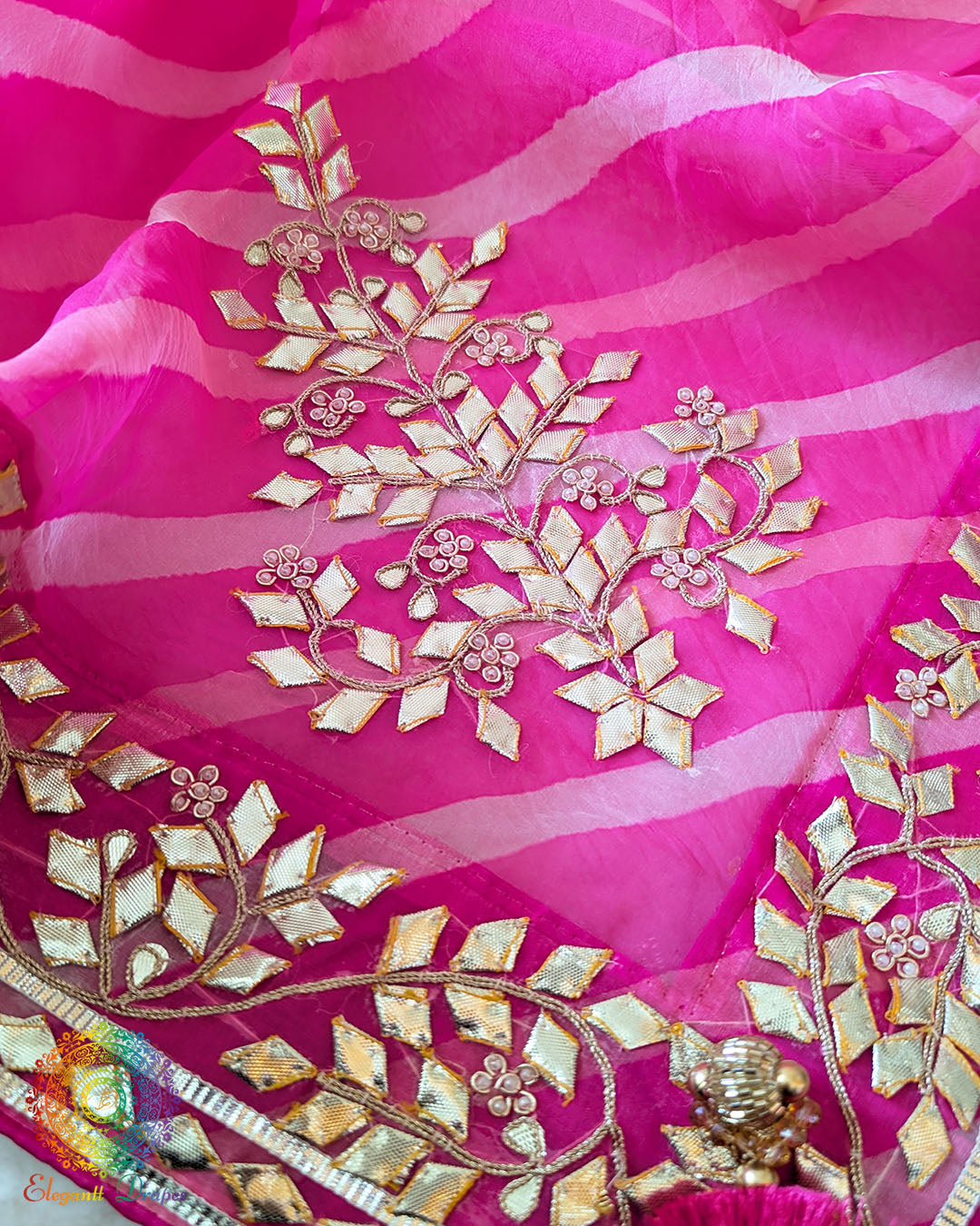 Pink Organza Saree – Detailed Leheria pattern enhanced with carefully handcrafted Kachha Gota embellishment across the saree body