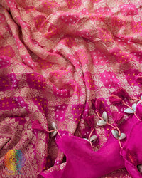 Close-up of traditional kodi tassels, zari border, and Bandhani motifs on pink peach shaded Banarasi georgette Gharchola dupatta