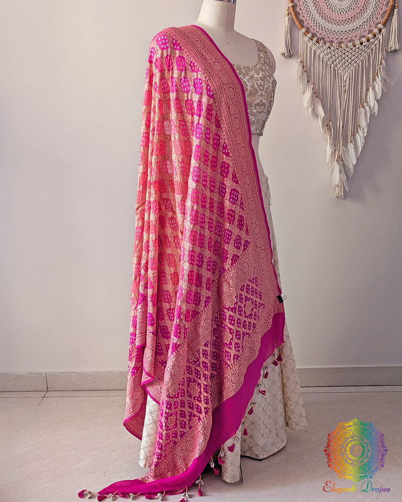 Side view of pink peach shaded Banarasi georgette Gharchola Bandhani dupatta showcasing elegant ombré shading, Gharchola checks, and Bandhani motifs