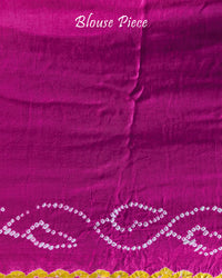 Matching blouse piece in pink shaded gaji silk fabric with bandhani detailing