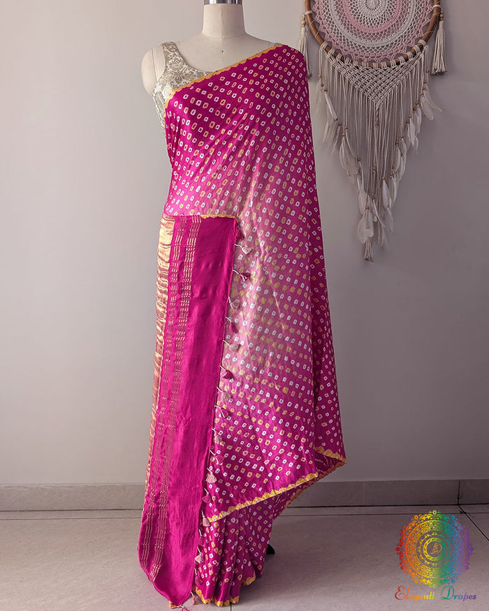 Pink shaded pure gaji silk saree with all-over bandhani dots on mannequin showing full drape