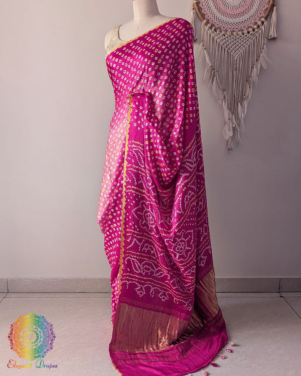 Side angle view of pink shaded bandhani saree highlighting fluid silk drape