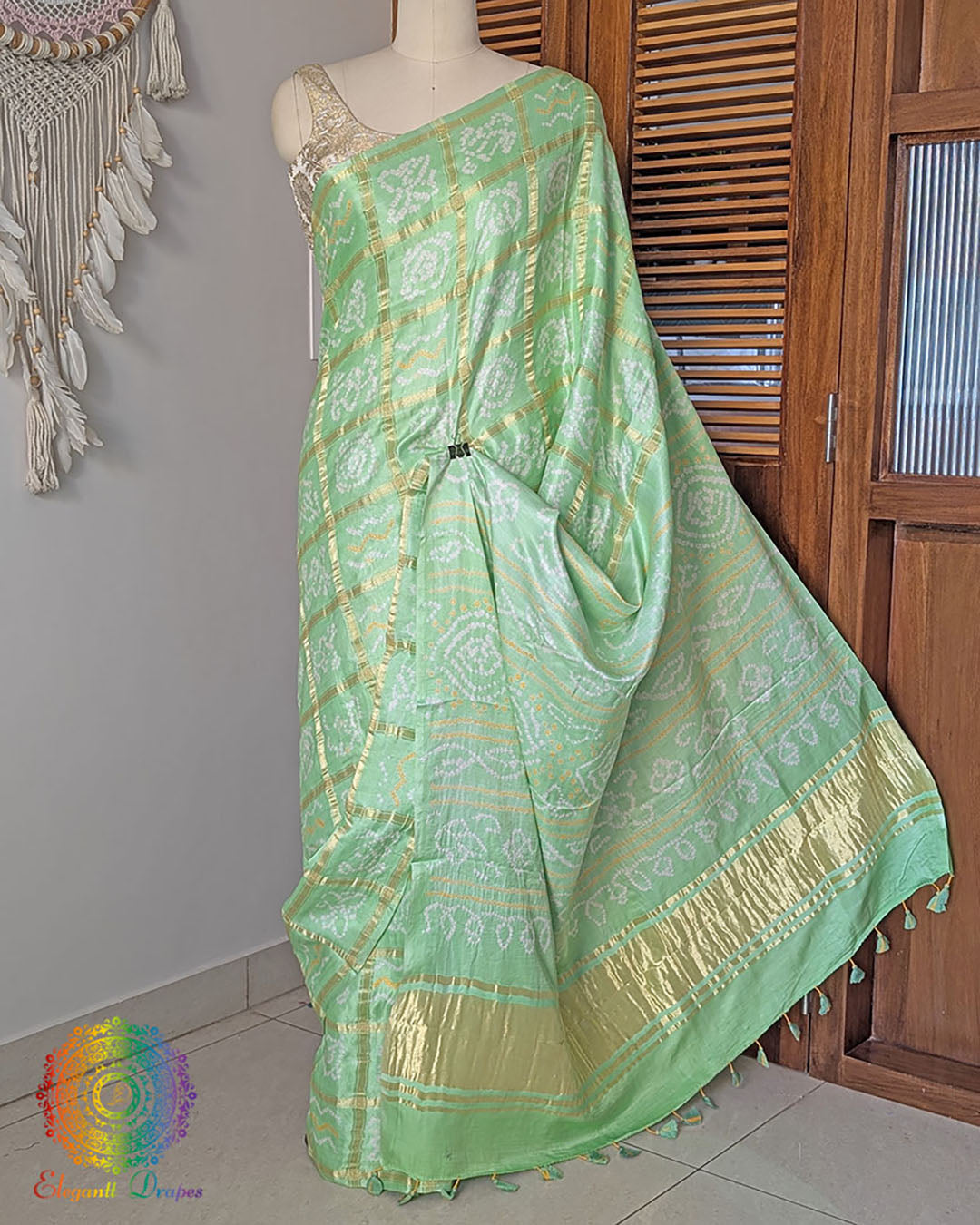Palla view of mint green bandhani saree on mannequin highlighting palla fall