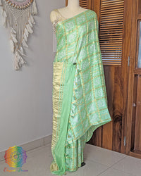 Mint green Gharchola gaji silk bandhani saree on mannequin showing full drape
