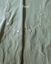 Front neck view of the Pista Green Kala Cotton Kutch Mirror Handwork blouse piece, showcasing detailed traditional embroidery and real mirrors arranged in a decorative handcrafted design.