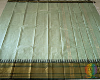 Full mint green Kanchi cotton saree laid open showcasing overall design and drape