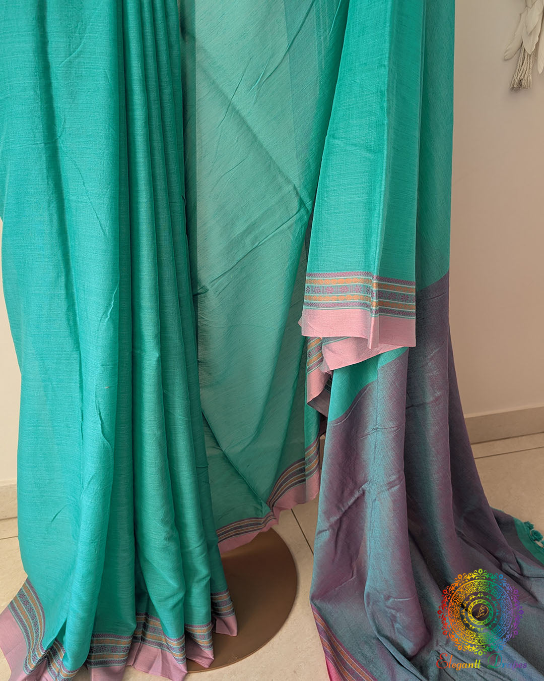 Close up of sea green bengal cotton saree showing soft cotton weave
