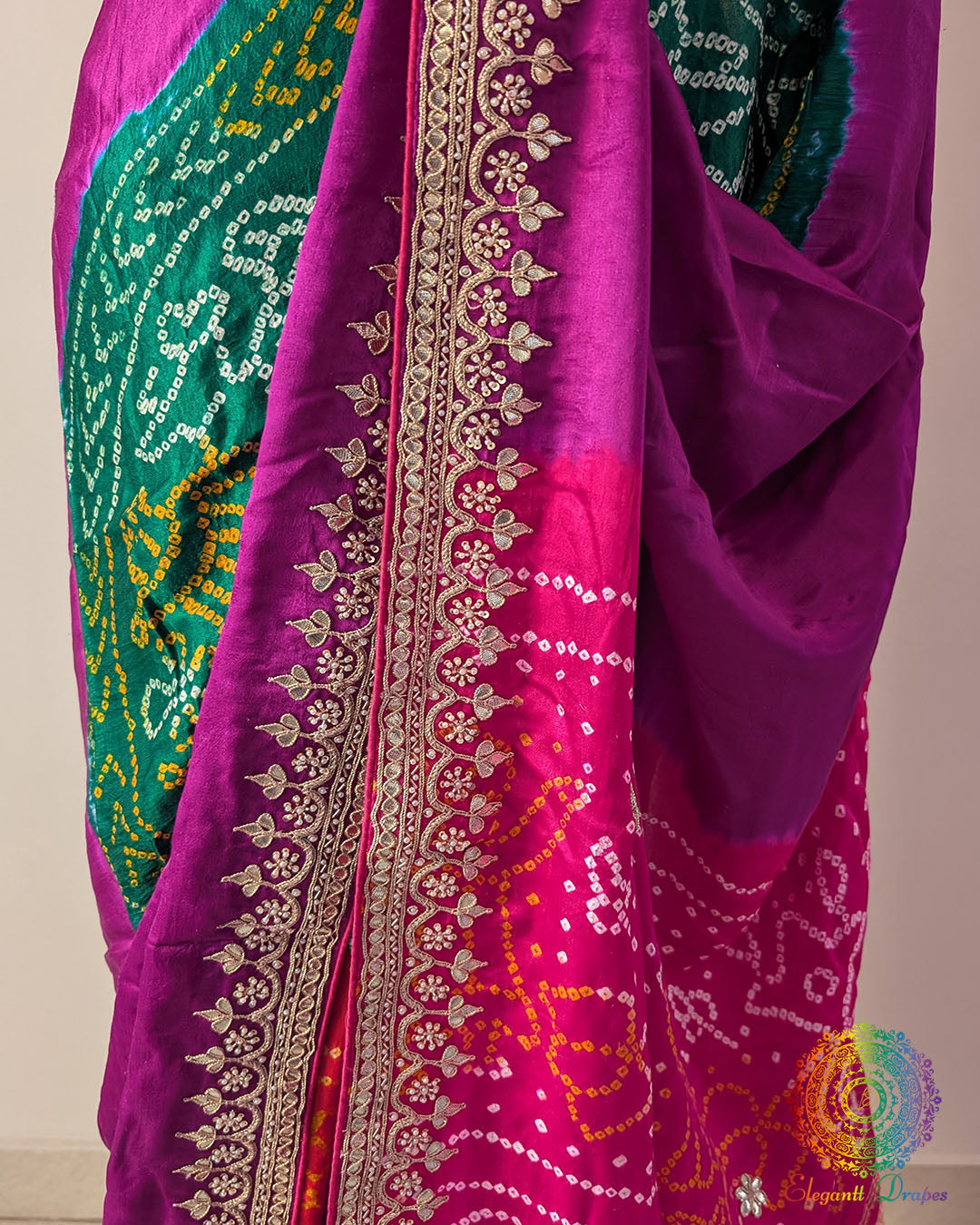 Close up of green, orange and pink Rasmandal motifs with gota patti detailing on gaji silk saree