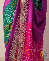 Close up of green, orange and pink Rasmandal motifs with gota patti detailing on gaji silk saree
