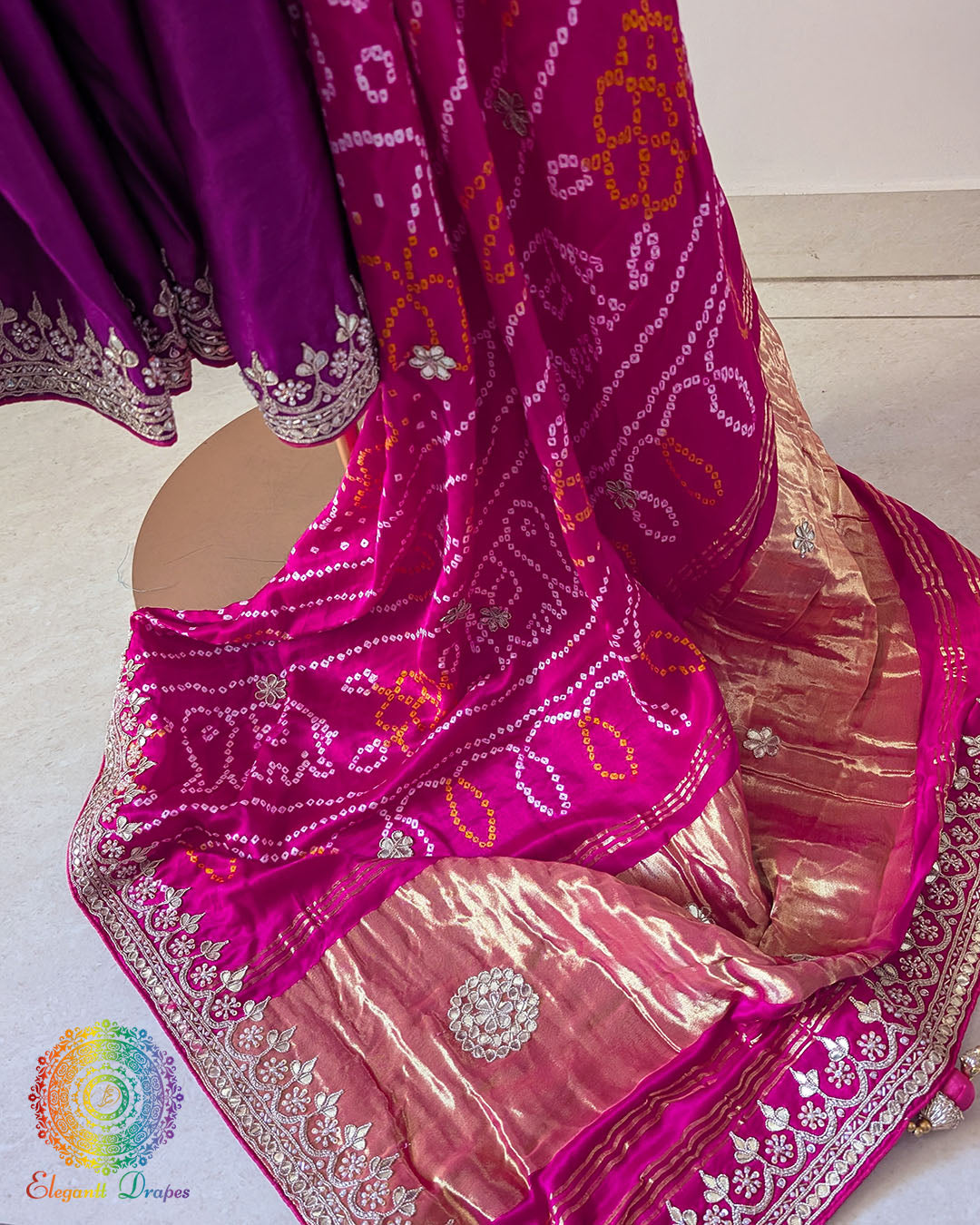 Open palla view of magenta gaji silk saree highlighting pink palla, gota patti border work, and Rasmandal motifs