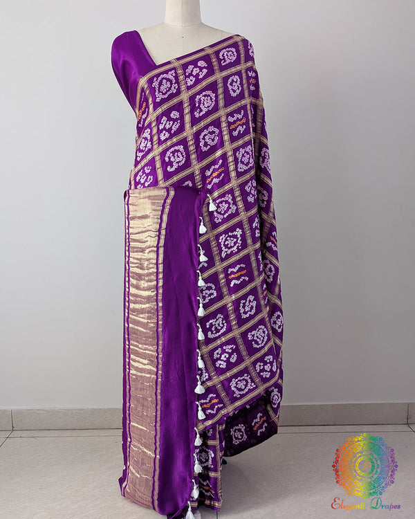 Violet Purple Pure Gaji Silk Bandhani Gharchola Saree in a front drape view, showcasing the rich purple base, white Bandhani motifs and gold-toned Gharchola checks.