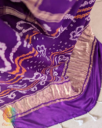 Close-up of the palla of the Violet Purple Pure Gaji Silk Bandhani Gharchola Saree, highlighting the traditional Bandhani motifs, gold-toned detailing and metallic border with decorative tassels.