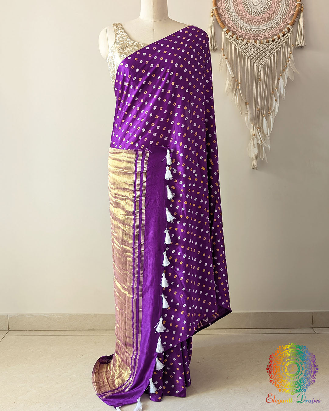 Purple gaji silk saree on mannequin showcasing traditional bandhani dots