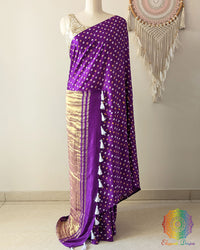 Purple gaji silk saree on mannequin showcasing traditional bandhani dots