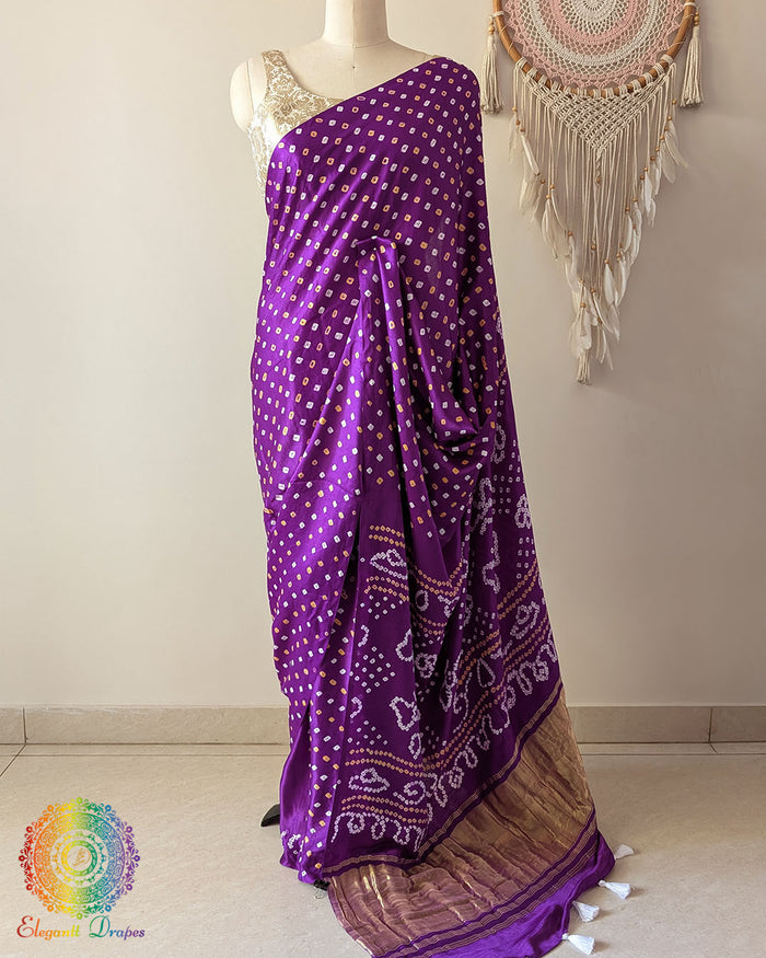 Purple pure gaji silk saree with all-over bandhani dots on mannequin showing full drape