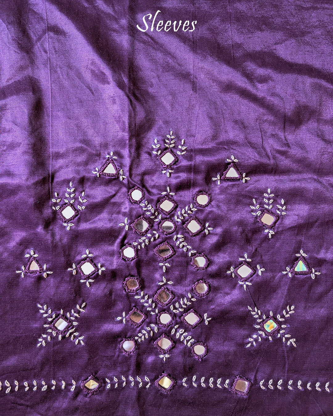 Sleeve detail of deep purple Mashru silk blouse piece featuring traditional Kutch mirror work