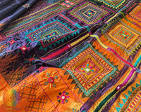Orange palla close up on blue Ilkal silk saree highlighting Lambani embroidery