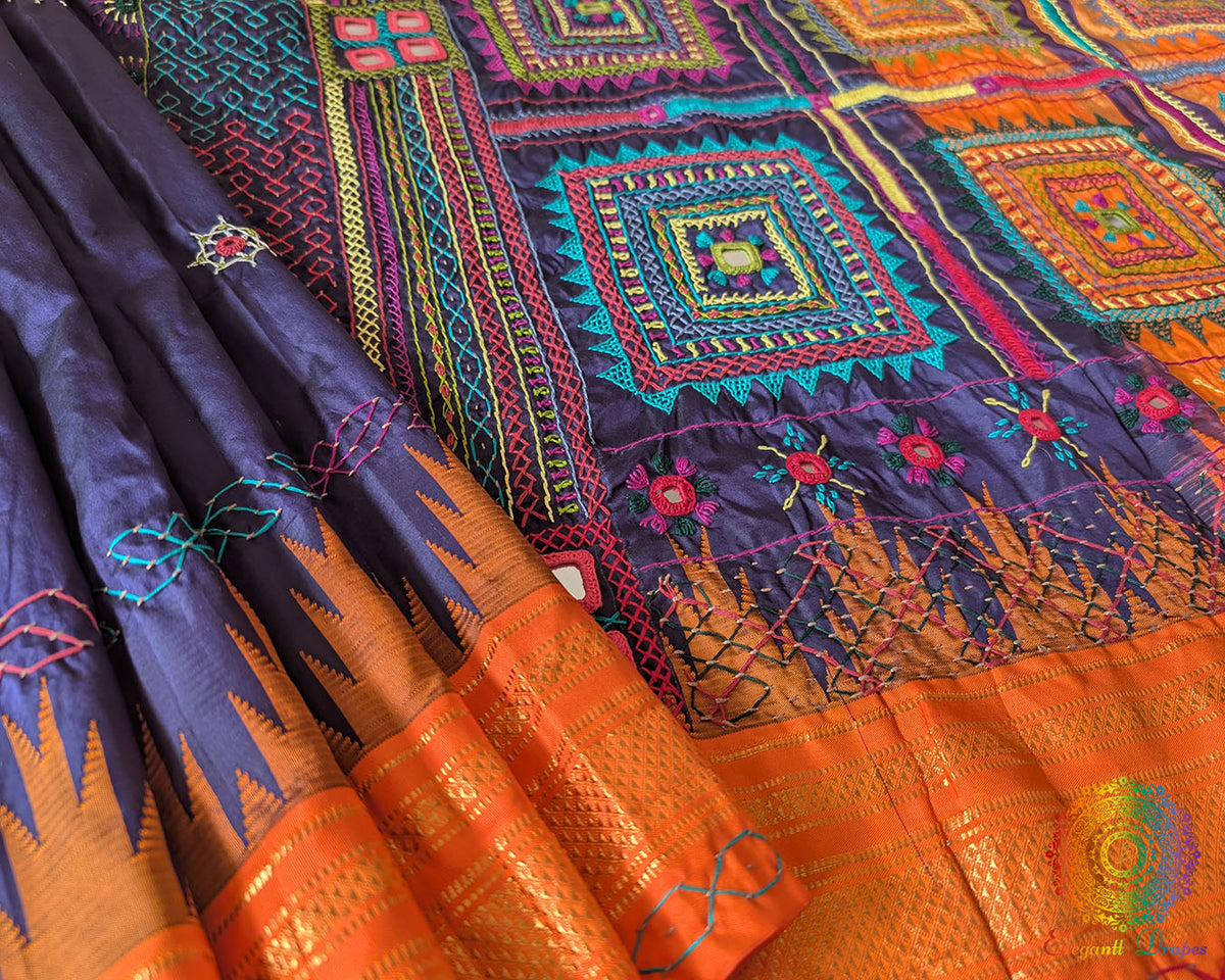 Orange border close up on blue Ilkal silk saree highlighting embroidery