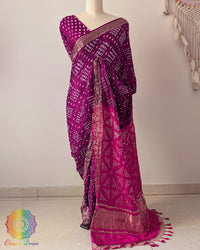 Purple pure gaji silk Bandhani saree on mannequin with pink palla and Nakshi woven border