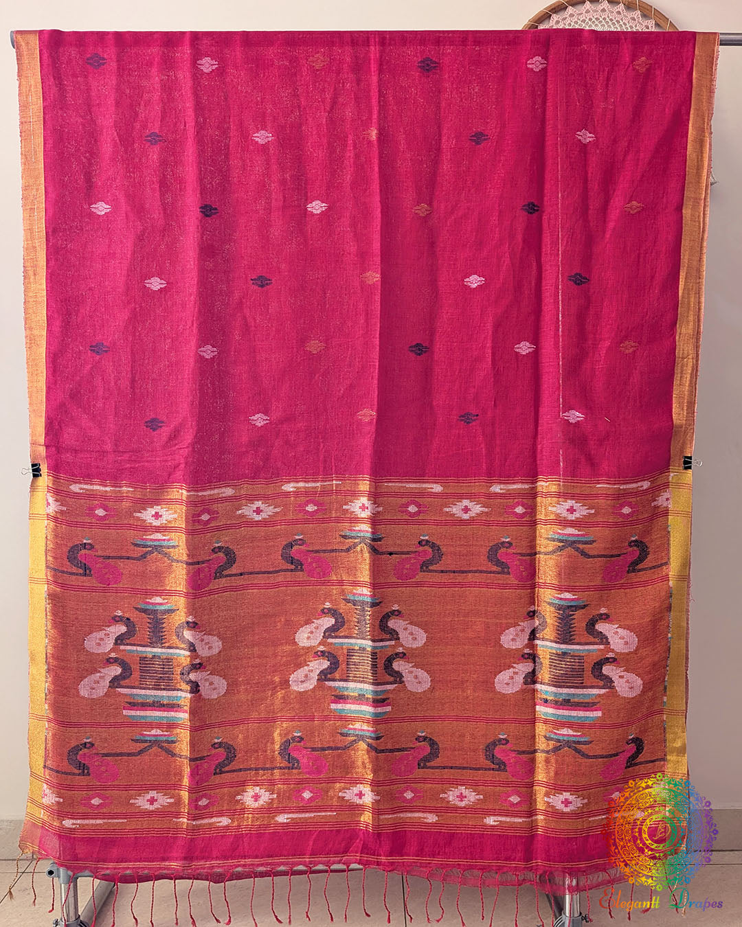 Full rani pink linen saree laid open showing overall design and layout