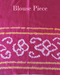 Matching blouse piece in magenta Gharchola bandhani silk showing fabric and pattern