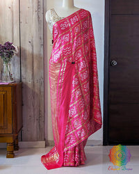 Magenta gaji silk saree on mannequin showcasing Gharchola pattern and bandhani detail