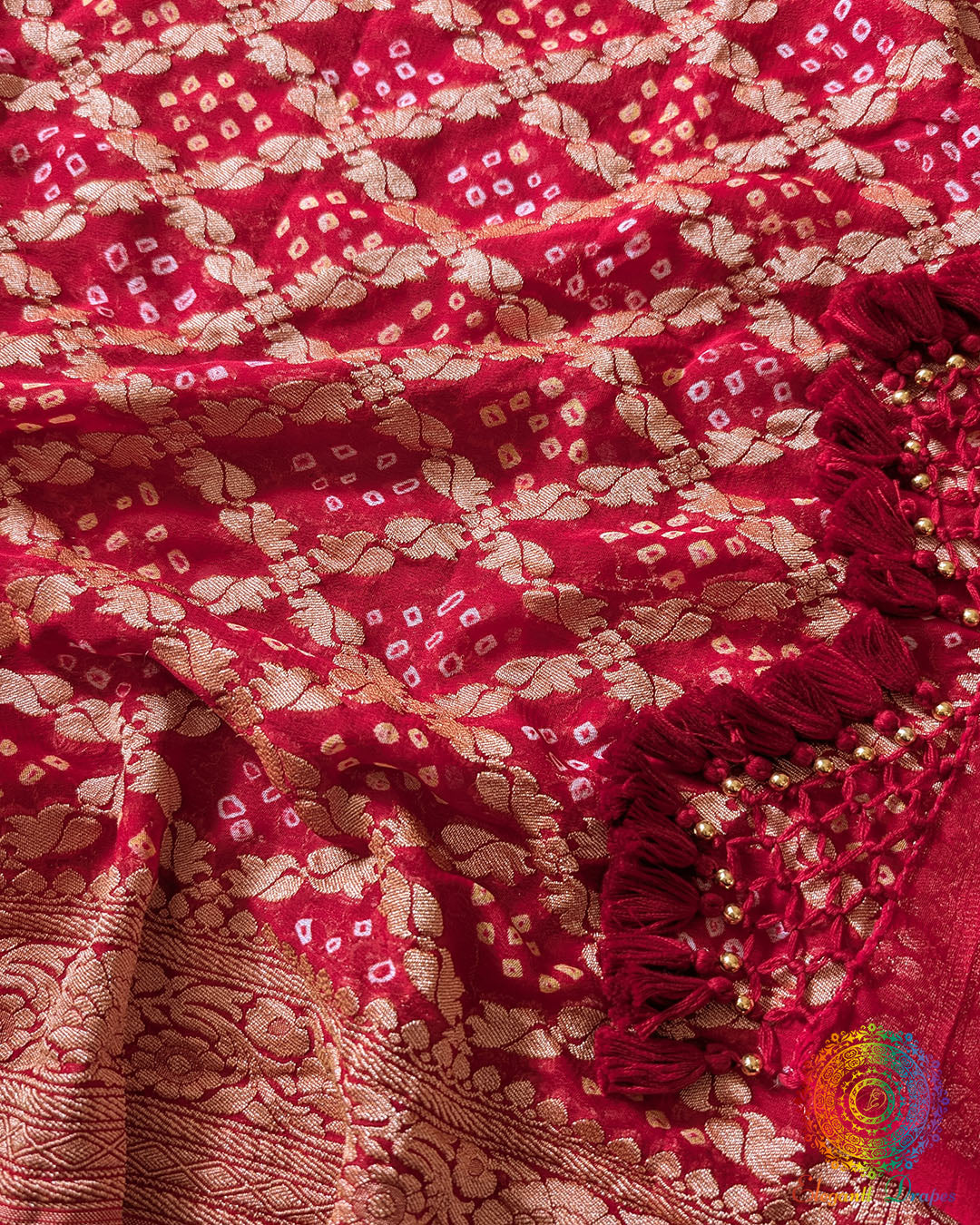 Close up of traditional Bandhani motifs on the red Khaddi georgette saree