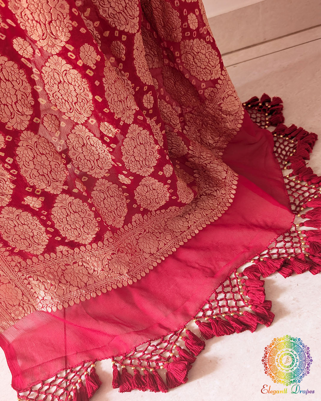Close up of the Banarasi woven palla on the red Khaddi georgette Bandhani saree