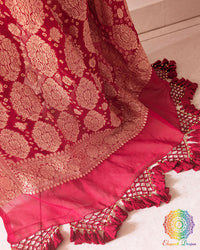 Close up of the Banarasi woven palla on the red Khaddi georgette Bandhani saree