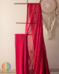 Red Bengal cotton saree fabric close up showing soft weave and embroidery-inspired motifs