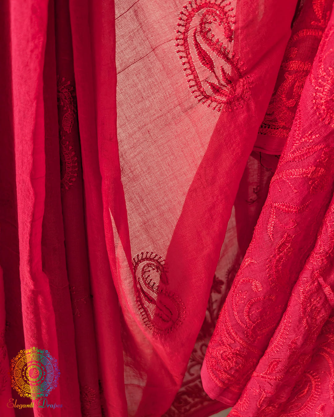 Close up of Chikankari-inspired paisley embroidery on red Bengal cotton saree