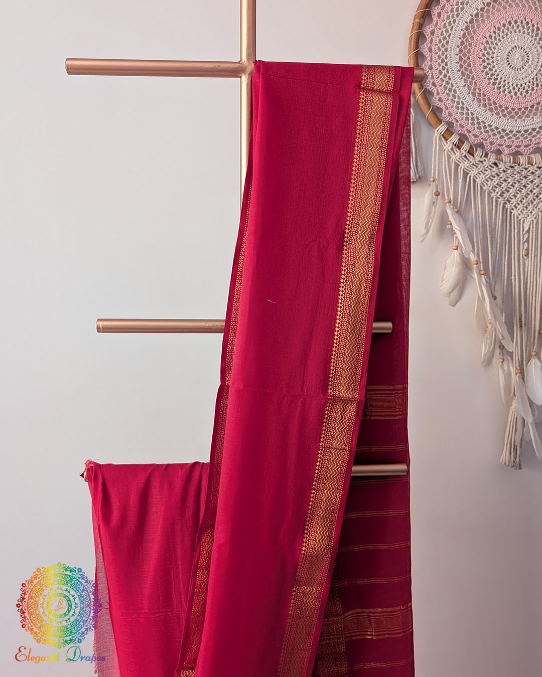 Red Bengal cotton saree body close up highlighting fabric texture with zari border detail