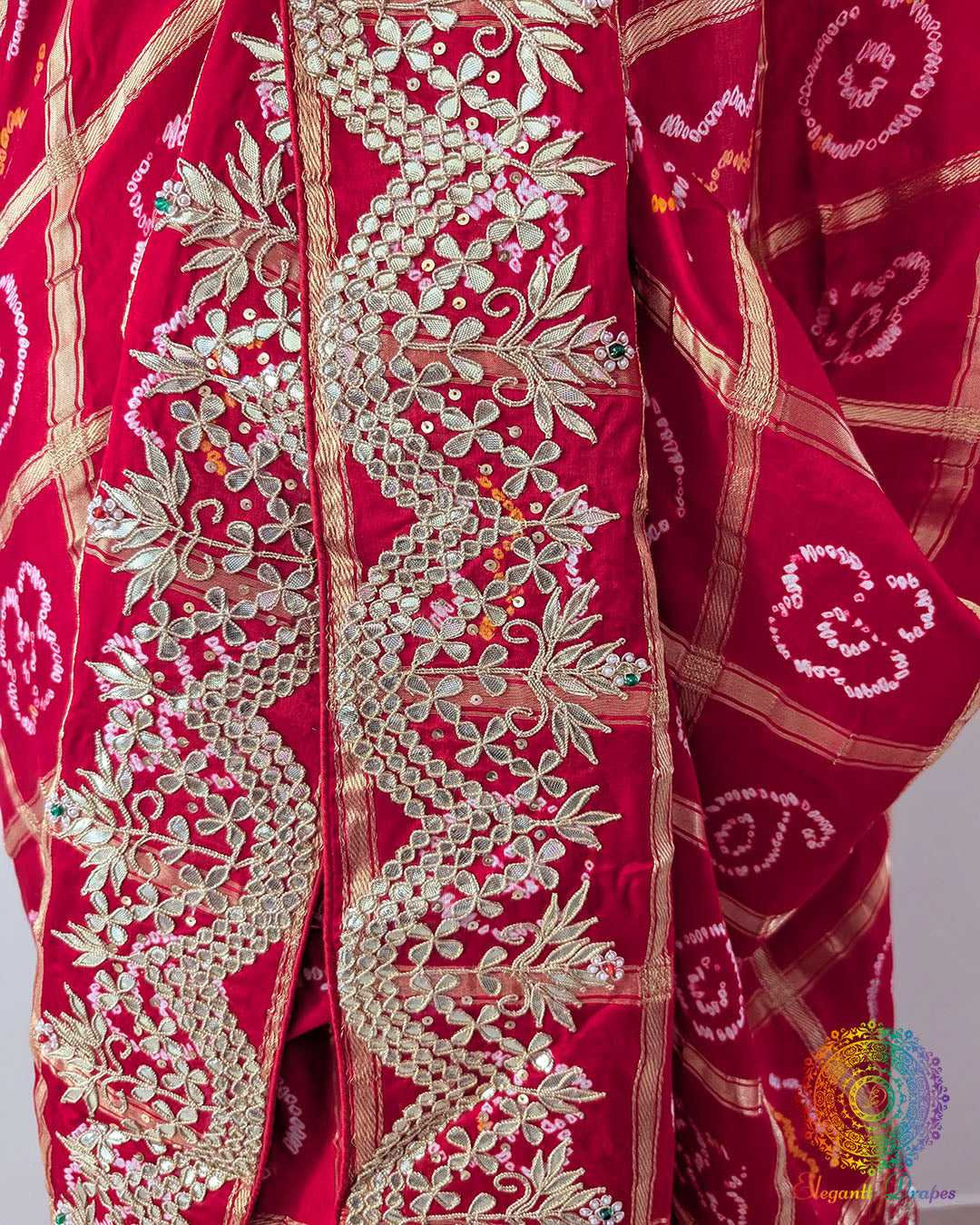 Close-up of the border of the Red Gaji Silk Gharchola Saree, showcasing the intricate Gota Patti embellishments, traditional patterns and rich Gaji Silk texture.