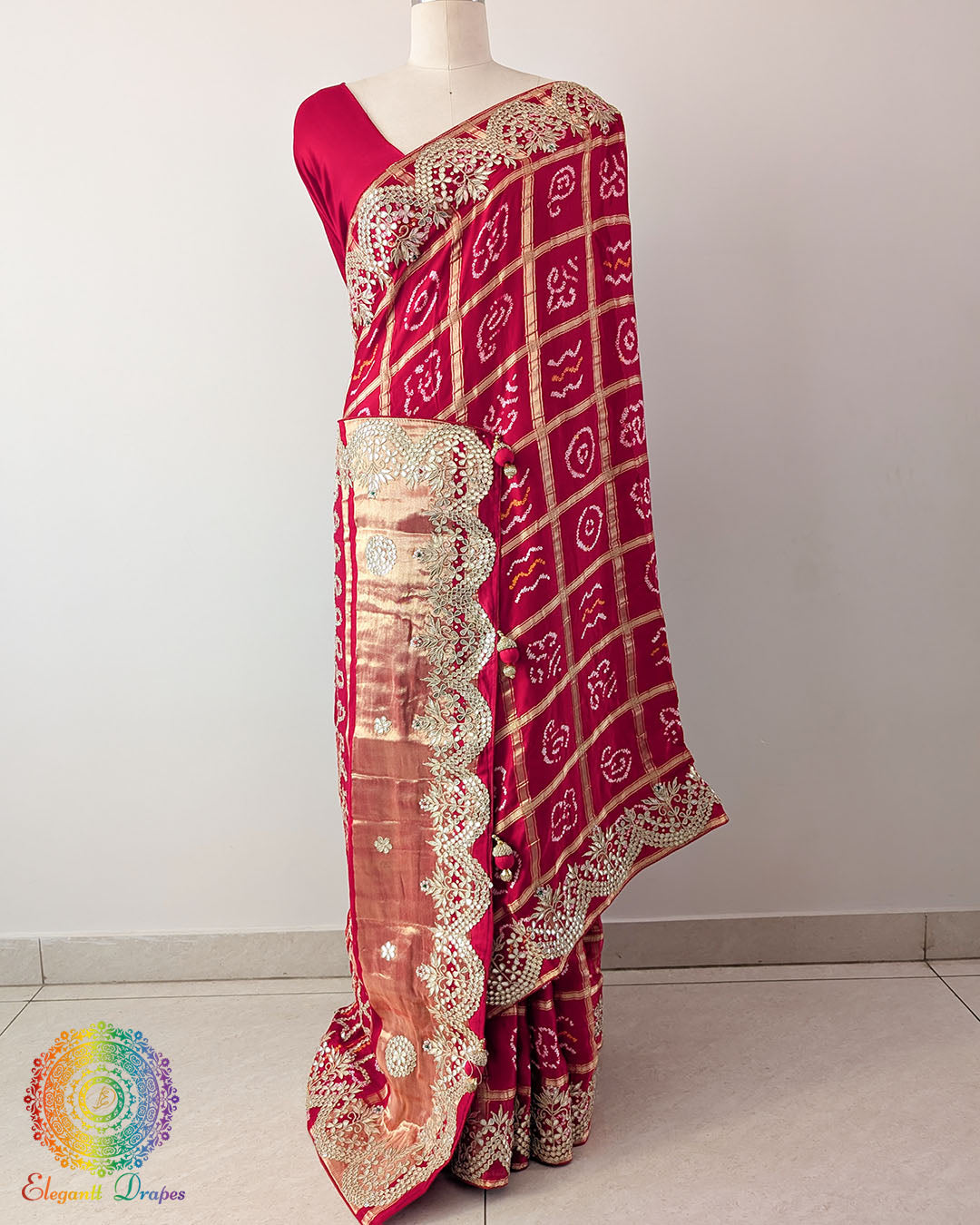 Red Gaji Silk Gharchola Saree with the palla visible in a draped view, displaying the traditional Gharchola design and decorative golden Gota Patti work.