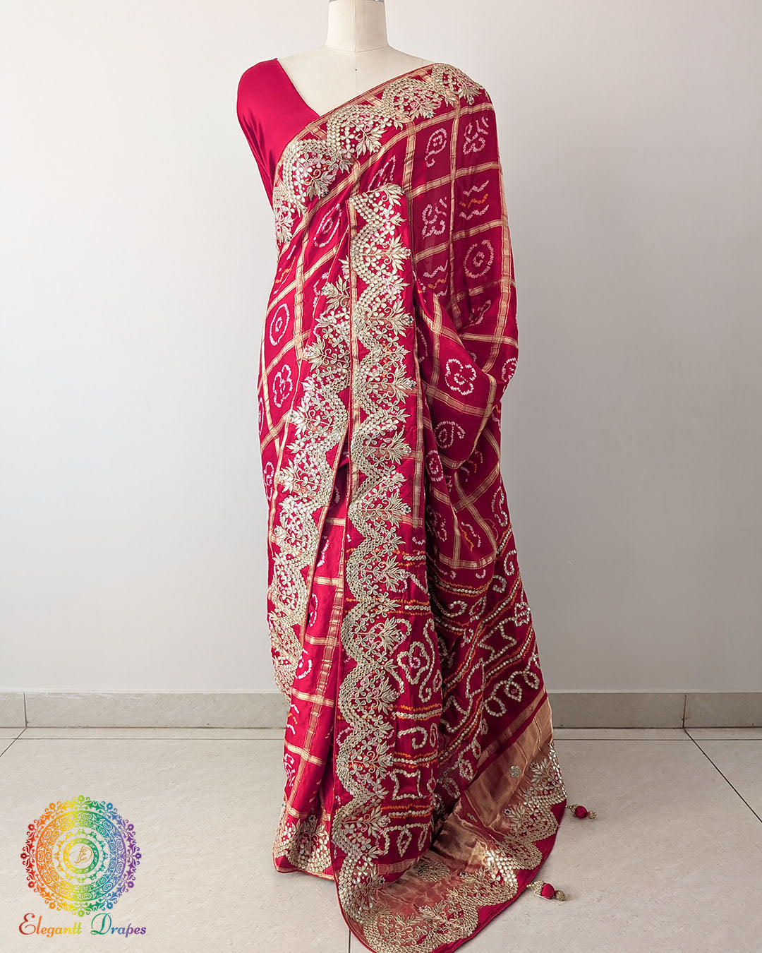 Red Gaji Silk Gharchola Saree with Gota Patti Work in a front drape view, showcasing the rich red colour, traditional Gharchola pattern and golden embellishments.